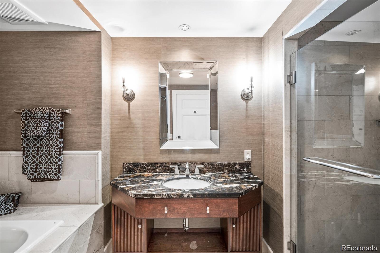 1891 Curtis Street, Unit 1607 Denver, CO 80202 - Photo 25 of 47 a bathroom with a granite countertop sink and a mirror
