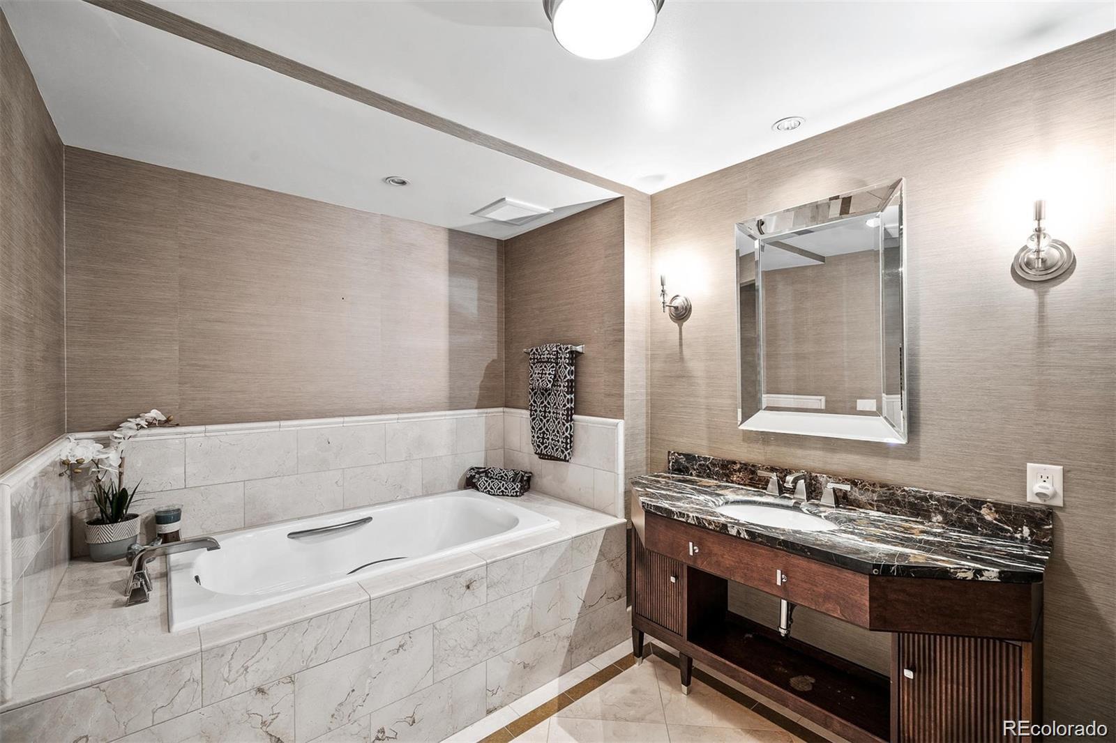 1891 Curtis Street, Unit 1607 Denver, CO 80202 - Photo 26 of 47 a bathroom with a tub a sink and a mirror