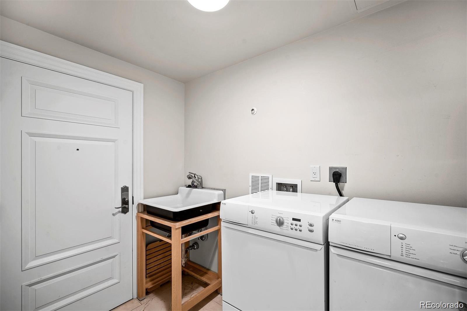 1891 Curtis Street, Unit 1607 Denver, CO 80202 - Photo 31 of 47 a utility room with dryer and washer