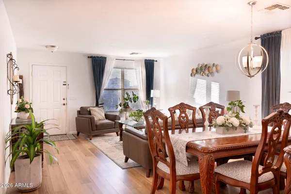 a view of a dining room with furniture and wooden floor