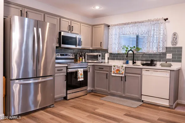 a kitchen with a refrigerator stove and microwave