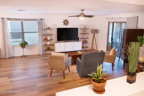 a living room with furniture a flat screen tv and a dining table