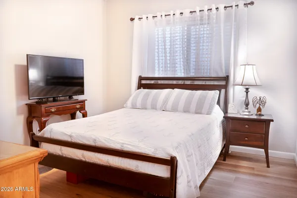 a bedroom with a bed and a flat screen tv