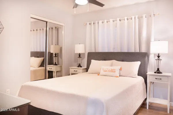 a bedroom with a bed and a chandelier