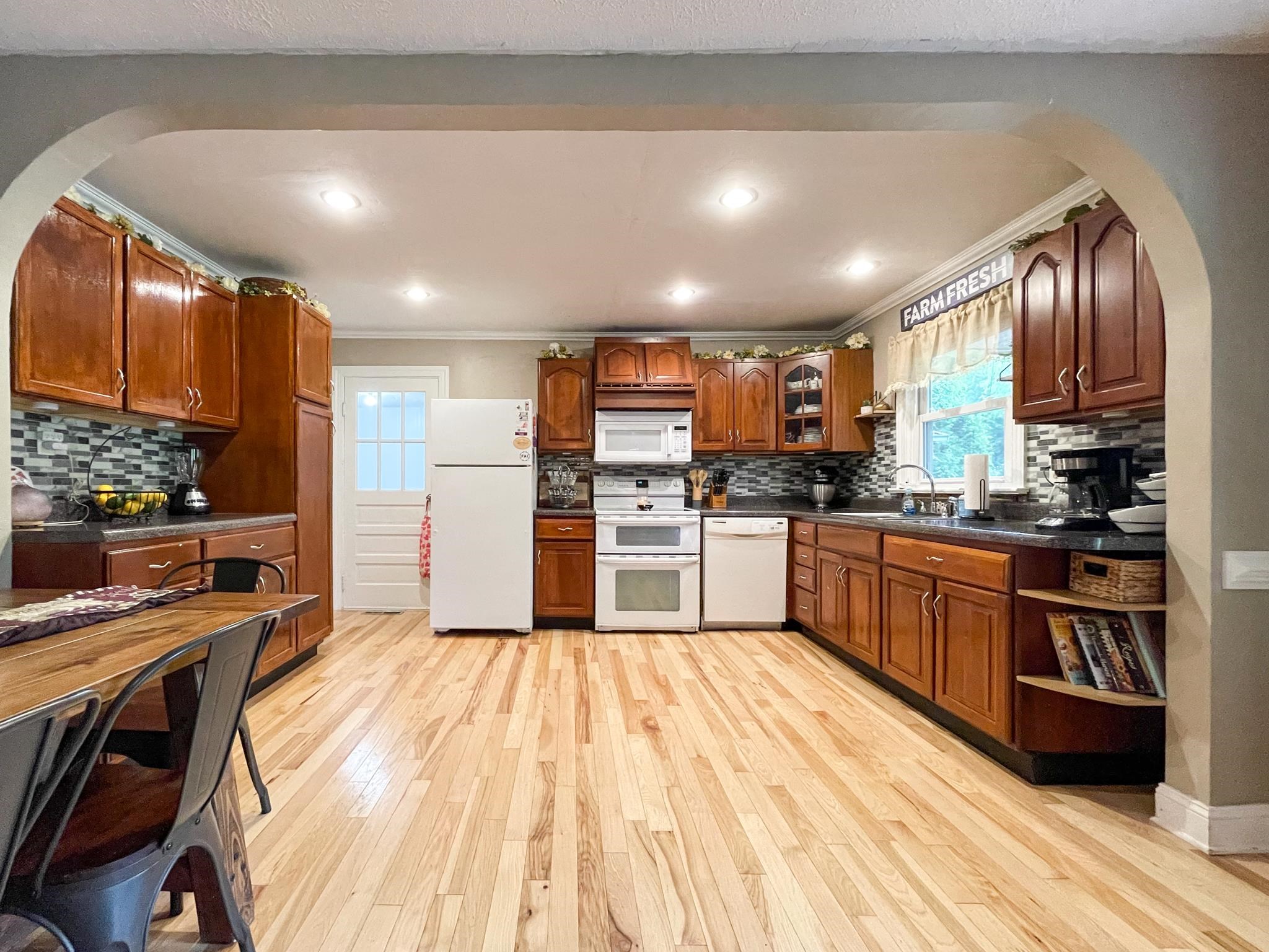 555 Dabneys Road Raphine, VA 24472 - Photo 13 of 30 a kitchen with stainless steel appliances granite countertop a refrigerator a stove and a sink with wooden floor