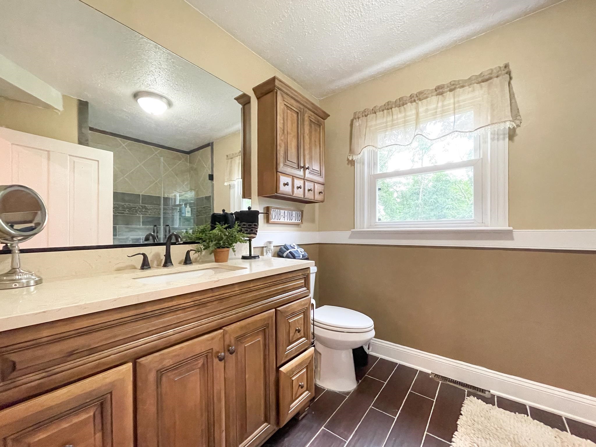 555 Dabneys Road Raphine, VA 24472 - Photo 19 of 30 a bathroom with a granite countertop sink mirror vanity and toilet