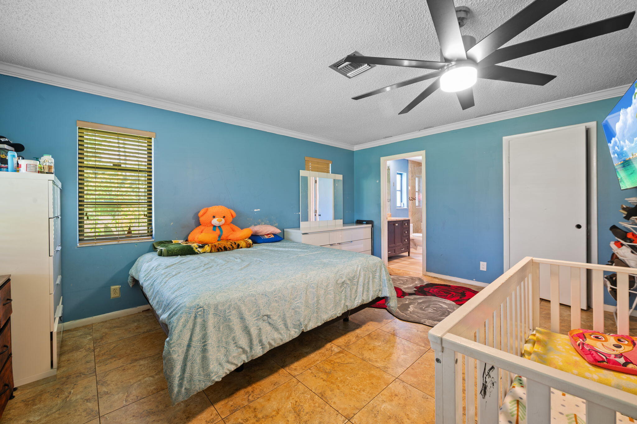 2587 E Road Loxahatchee Groves, FL 33470 - Photo 12 of 46 a bedroom with a bed and window