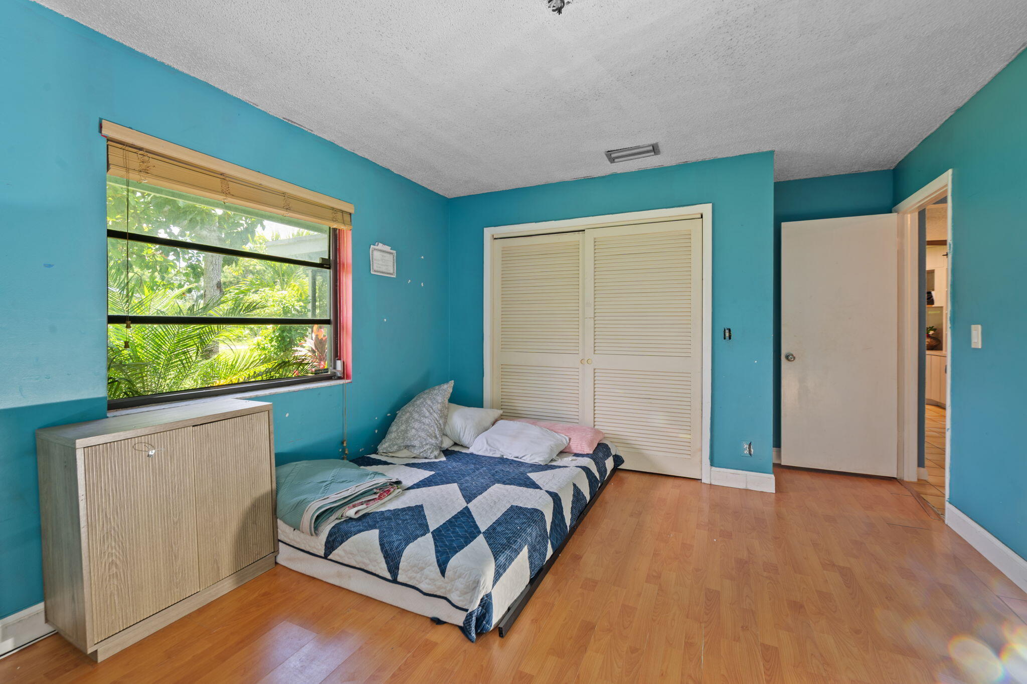 2587 E Road Loxahatchee Groves, FL 33470 - Photo 14 of 46 a bedroom with a bed and window