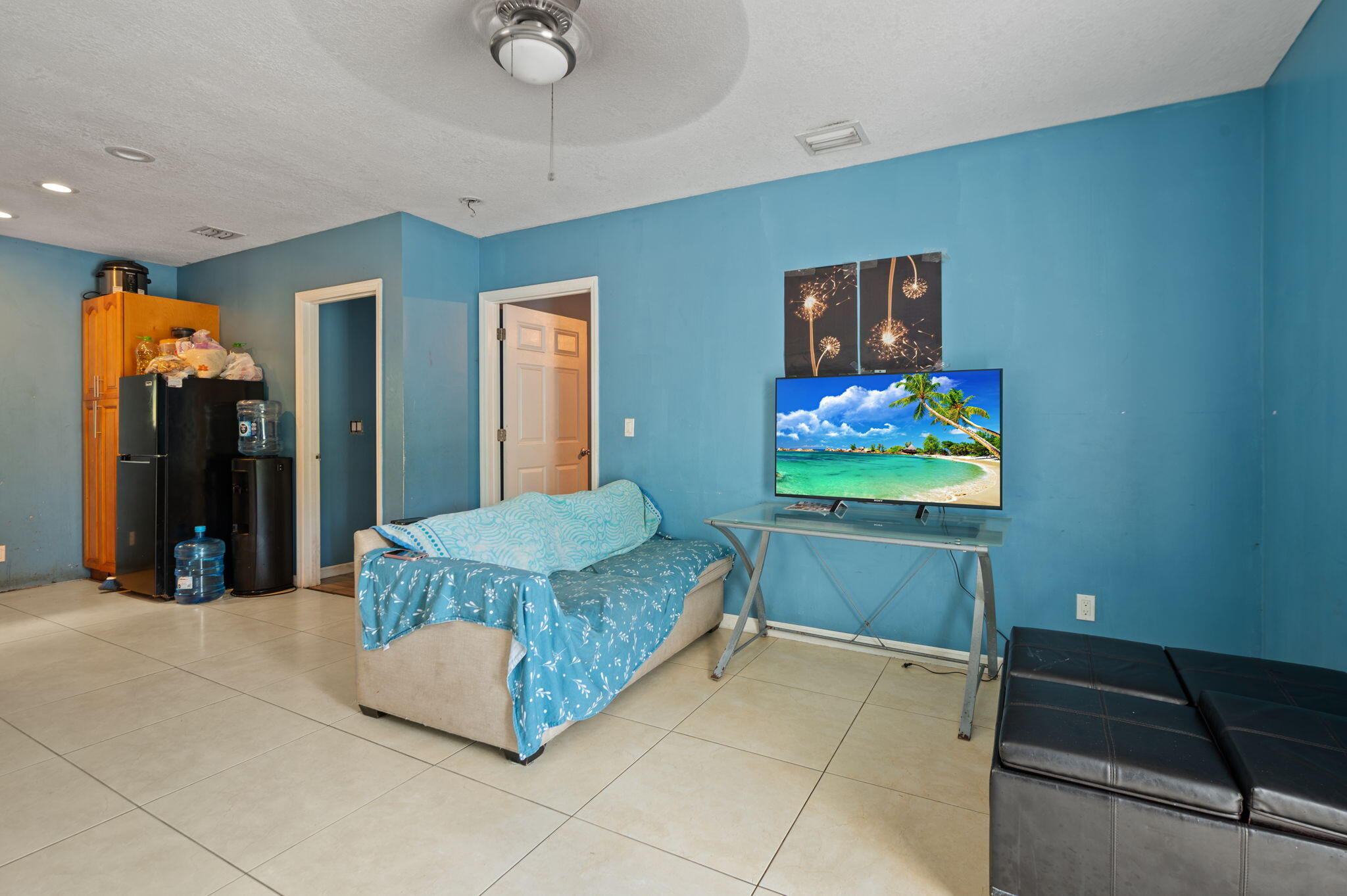 2587 E Road Loxahatchee Groves, FL 33470 - Photo 16 of 46 a living room with furniture and a flat screen tv