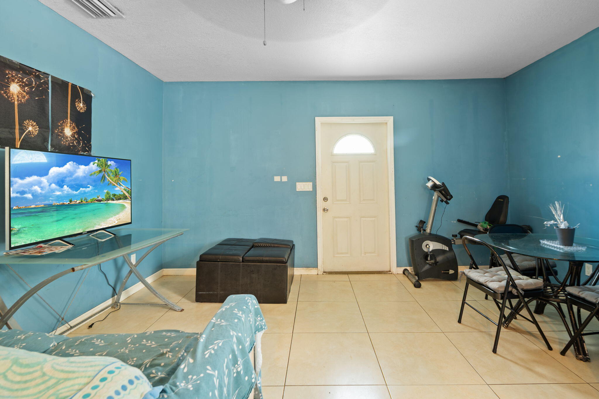 2587 E Road Loxahatchee Groves, FL 33470 - Photo 17 of 46 a bedroom with furniture and a flat screen tv