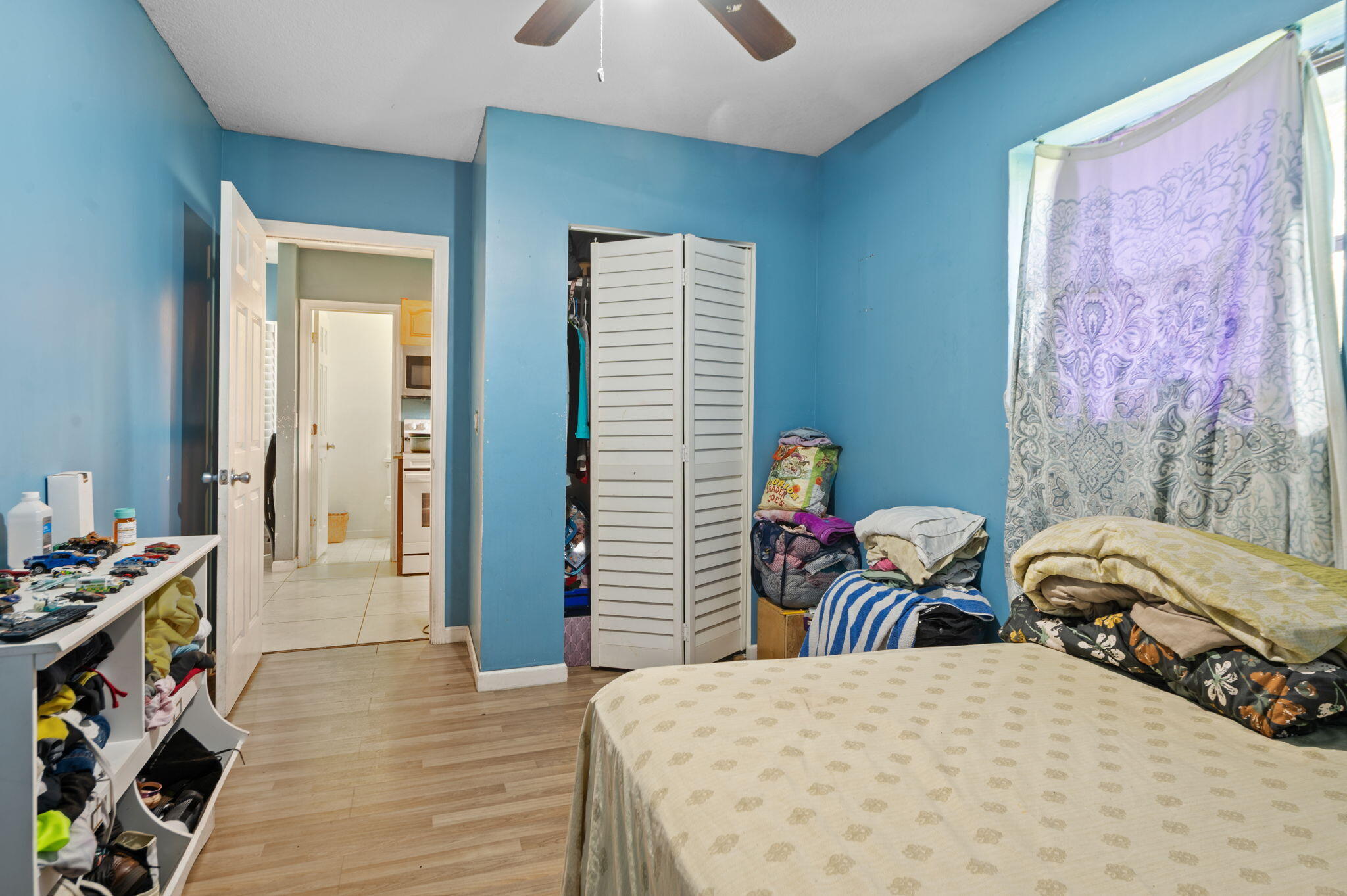 2587 E Road Loxahatchee Groves, FL 33470 - Photo 20 of 46 a bedroom with a bed and a tv in it