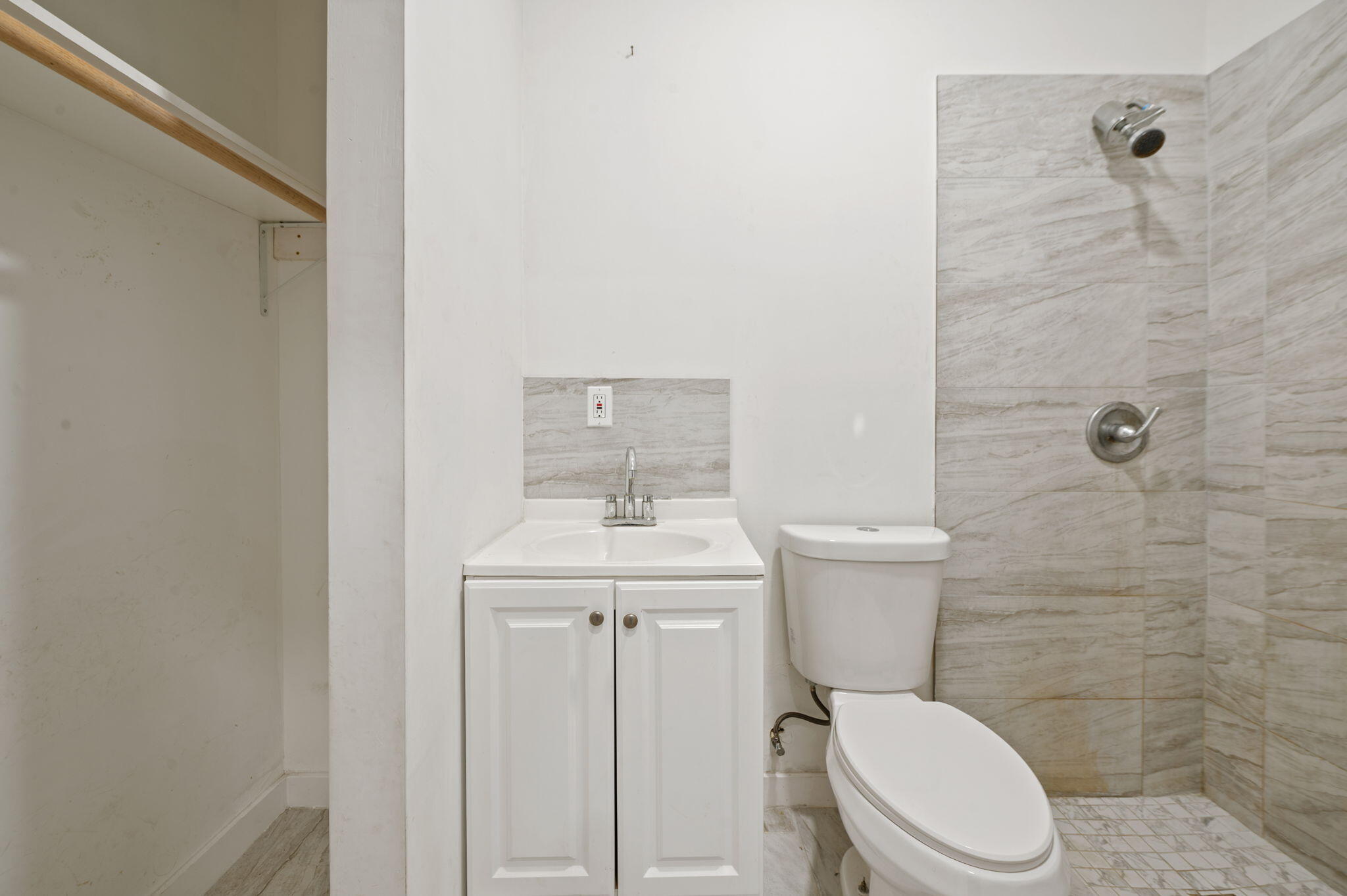 2587 E Road Loxahatchee Groves, FL 33470 - Photo 31 of 46 a white toilet sitting next to a bathroom sink