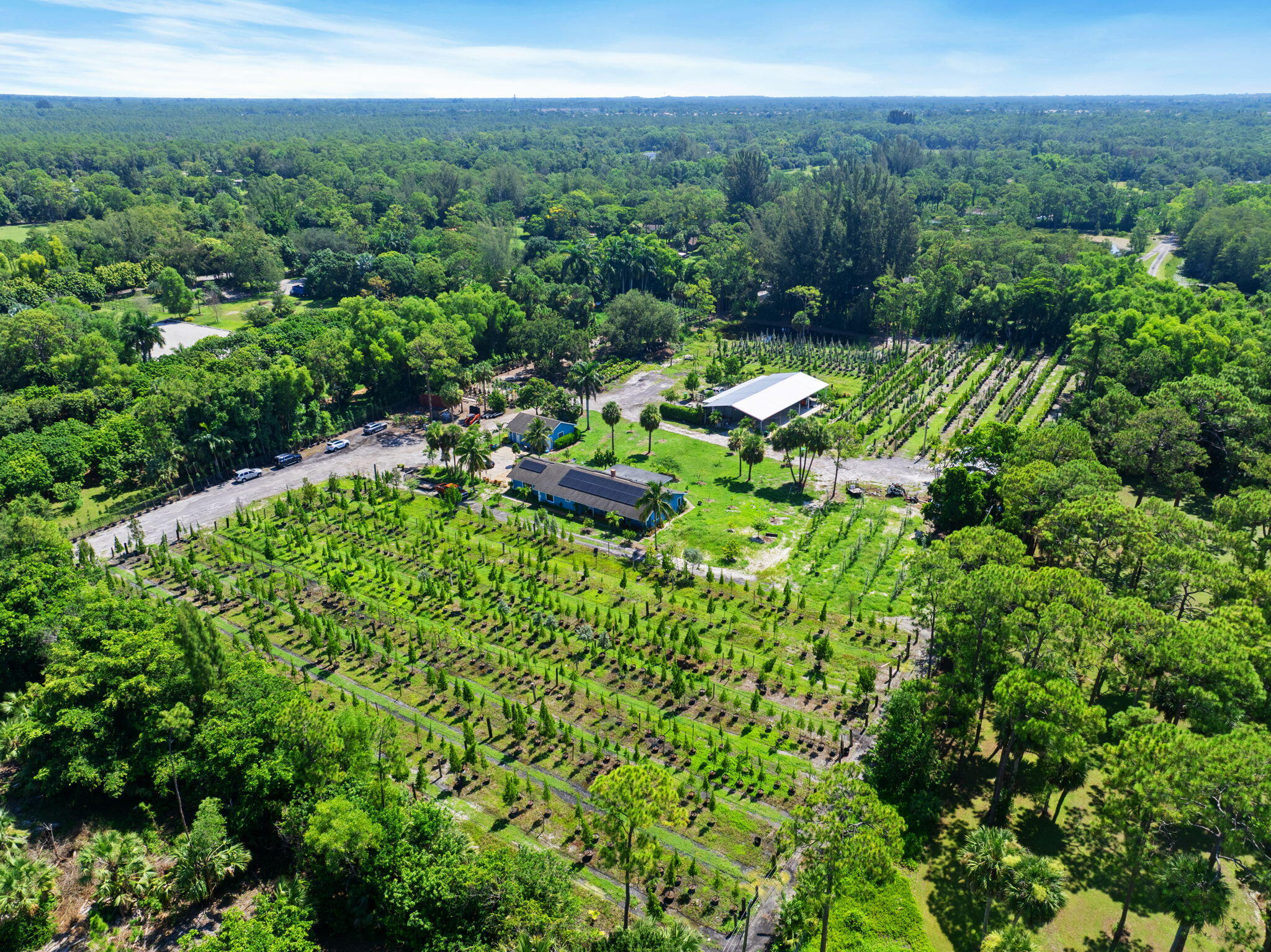 2587 E Road Loxahatchee Groves, FL 33470 - Photo 37 of 46 a view of a lake with a house