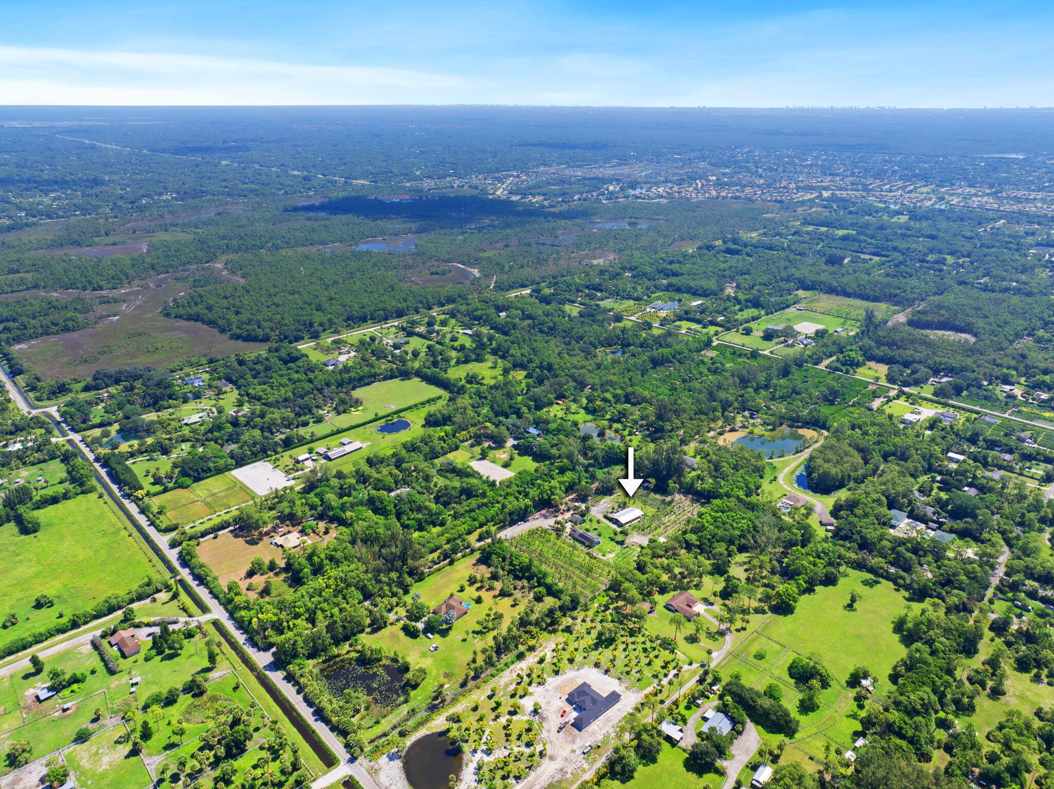 2587 E Road Loxahatchee Groves, FL 33470 - Photo 38 of 46 an aerial view of a houses with a yard