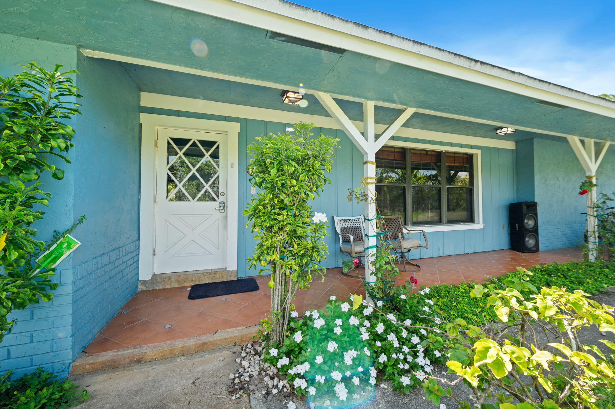 2587 E Road Loxahatchee Groves, FL 33470 - Photo 4 of 46 a front view of a house with garden