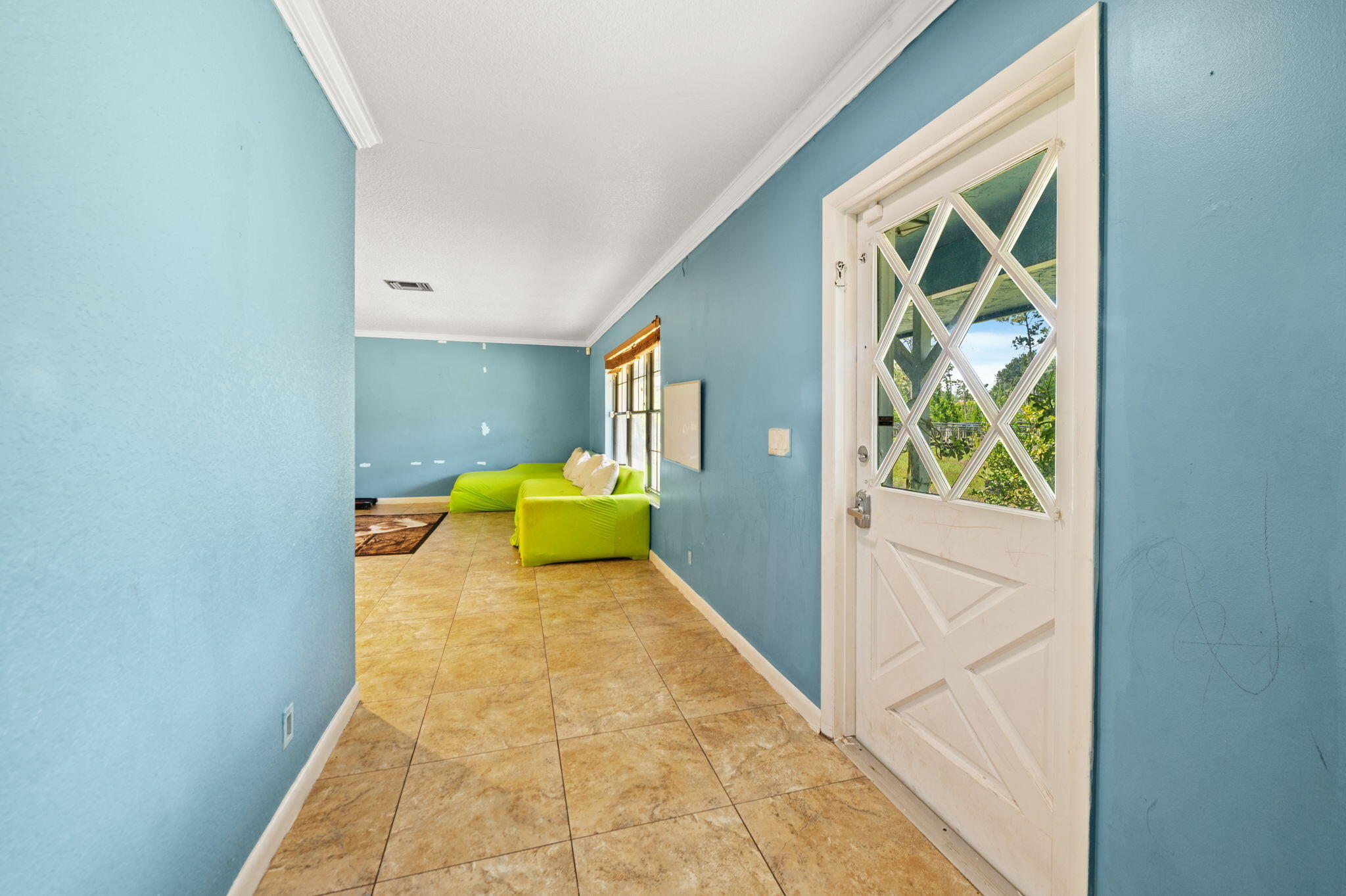 2587 E Road Loxahatchee Groves, FL 33470 - Photo 5 of 46 a en suite bathroom with a granite countertop sink and a mirror