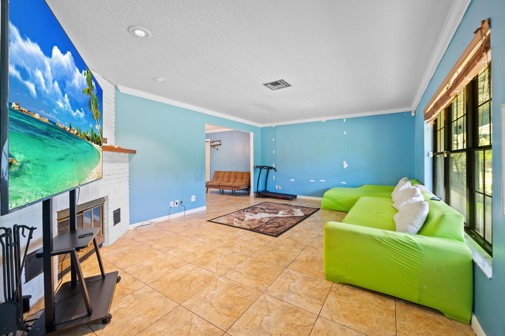 2587 E Road Loxahatchee Groves, FL 33470 - Photo 6 of 46 a bedroom with a bed and a couch