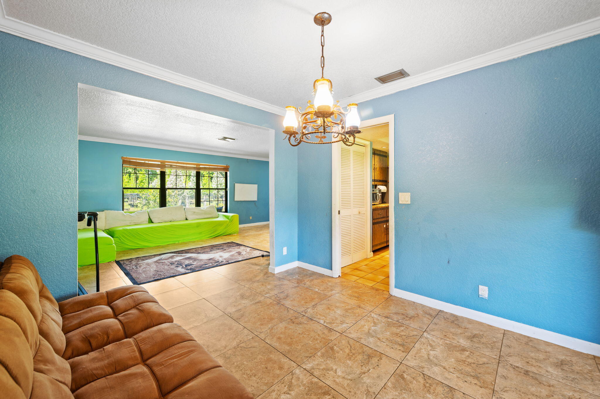 2587 E Road Loxahatchee Groves, FL 33470 - Photo 8 of 46 a room with furniture and a chandelier