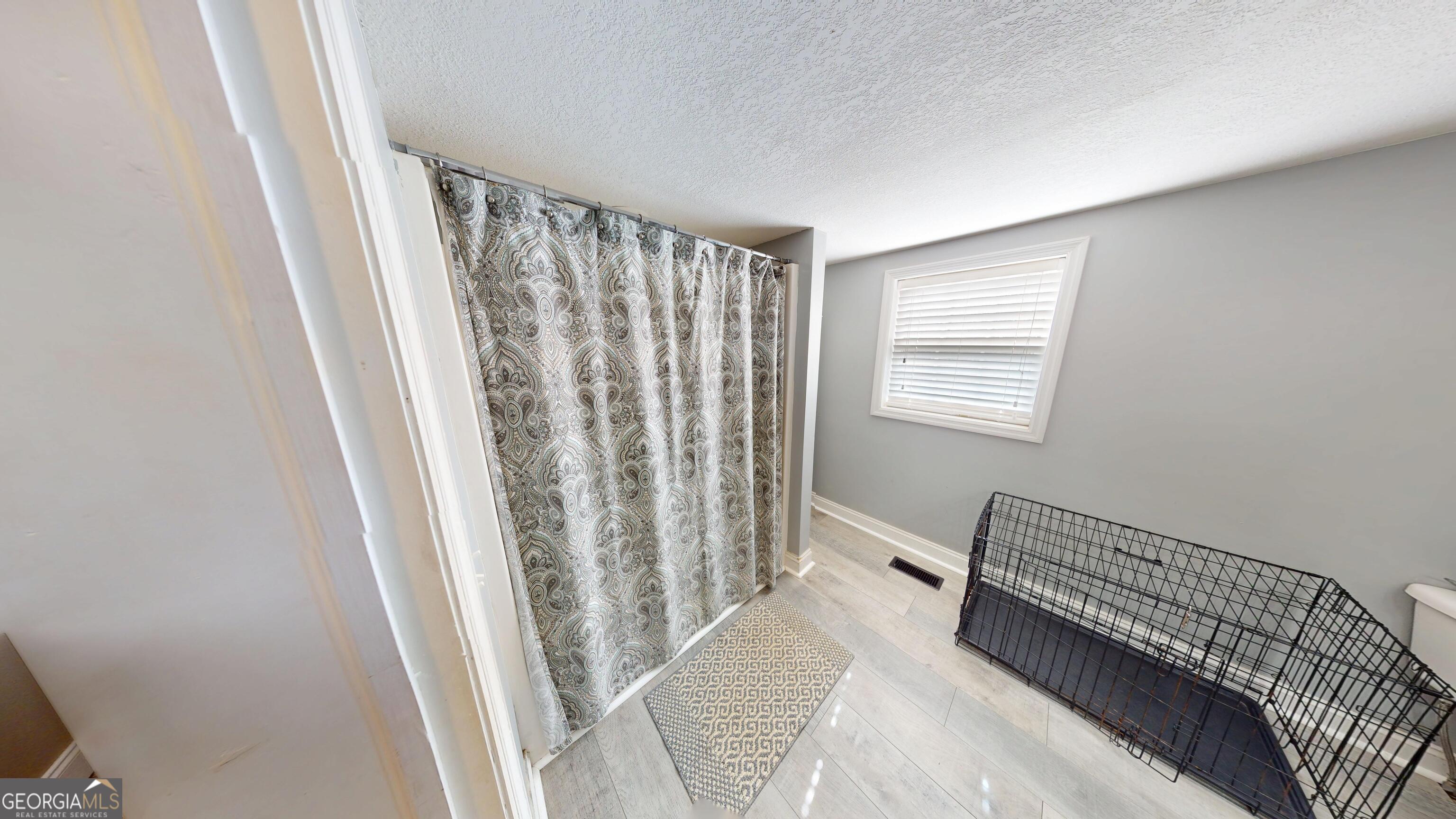 184 Eagle Pass Swainsboro, GA 30401 - Photo 11 of 49 a view of a bedroom with wooden floor and chair