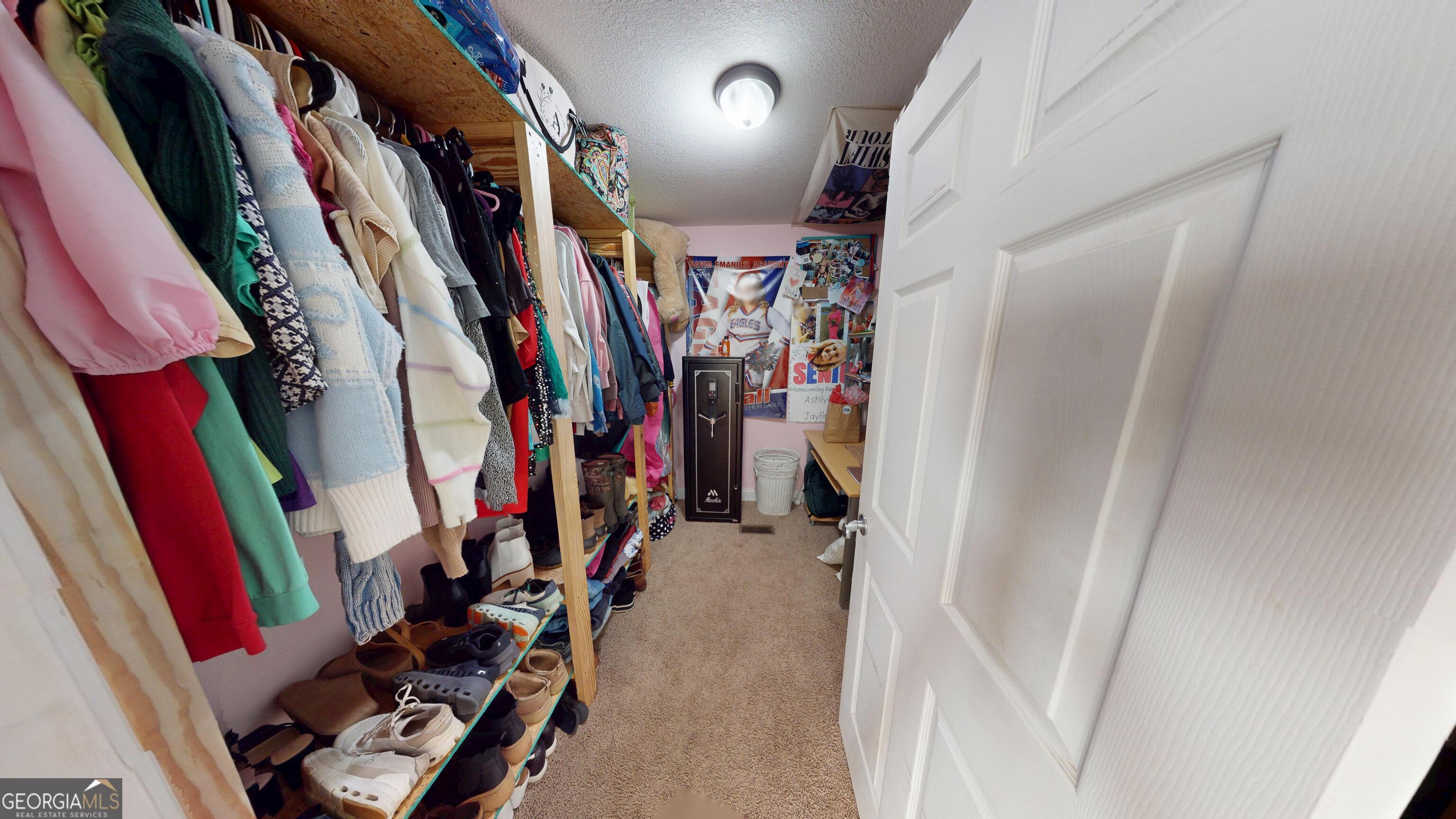 184 Eagle Pass Swainsboro, GA 30401 - Photo 18 of 49 a view of walk in closet with clothes