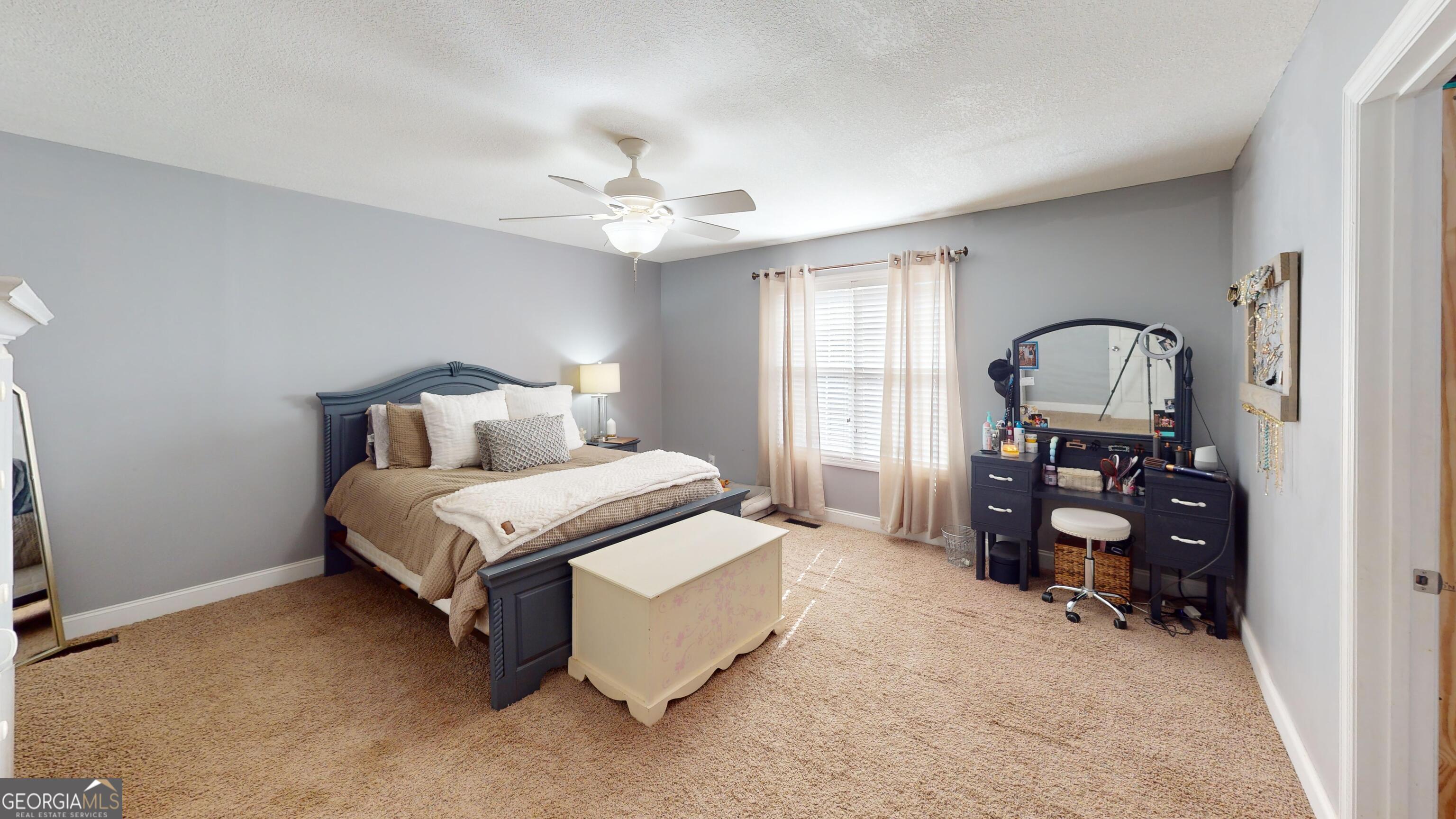 184 Eagle Pass Swainsboro, GA 30401 - Photo 29 of 49 a bedroom with a bed and a chandelier