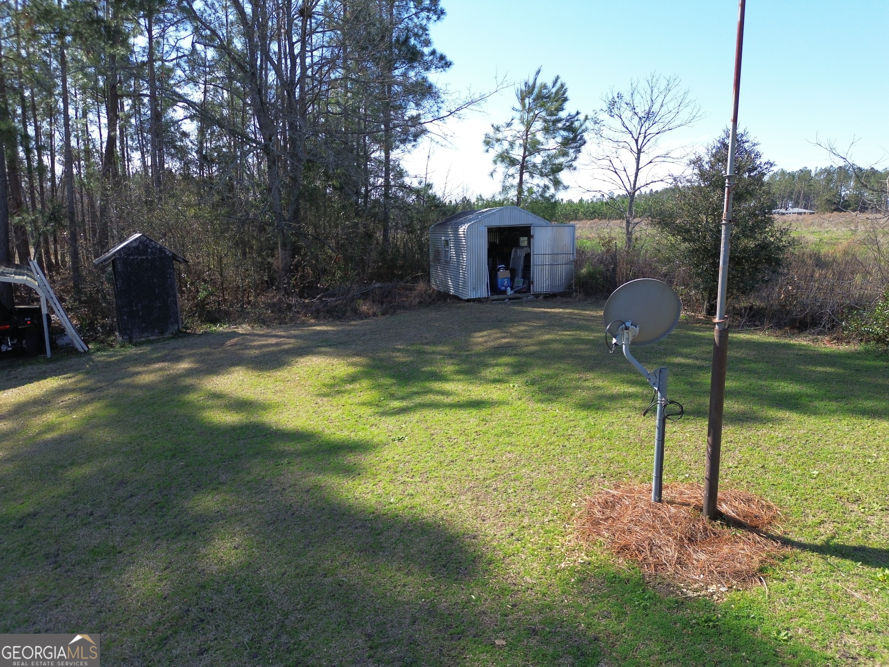 184 Eagle Pass Swainsboro, GA 30401 - Photo 37 of 49 a swimming pool with some trees in the background