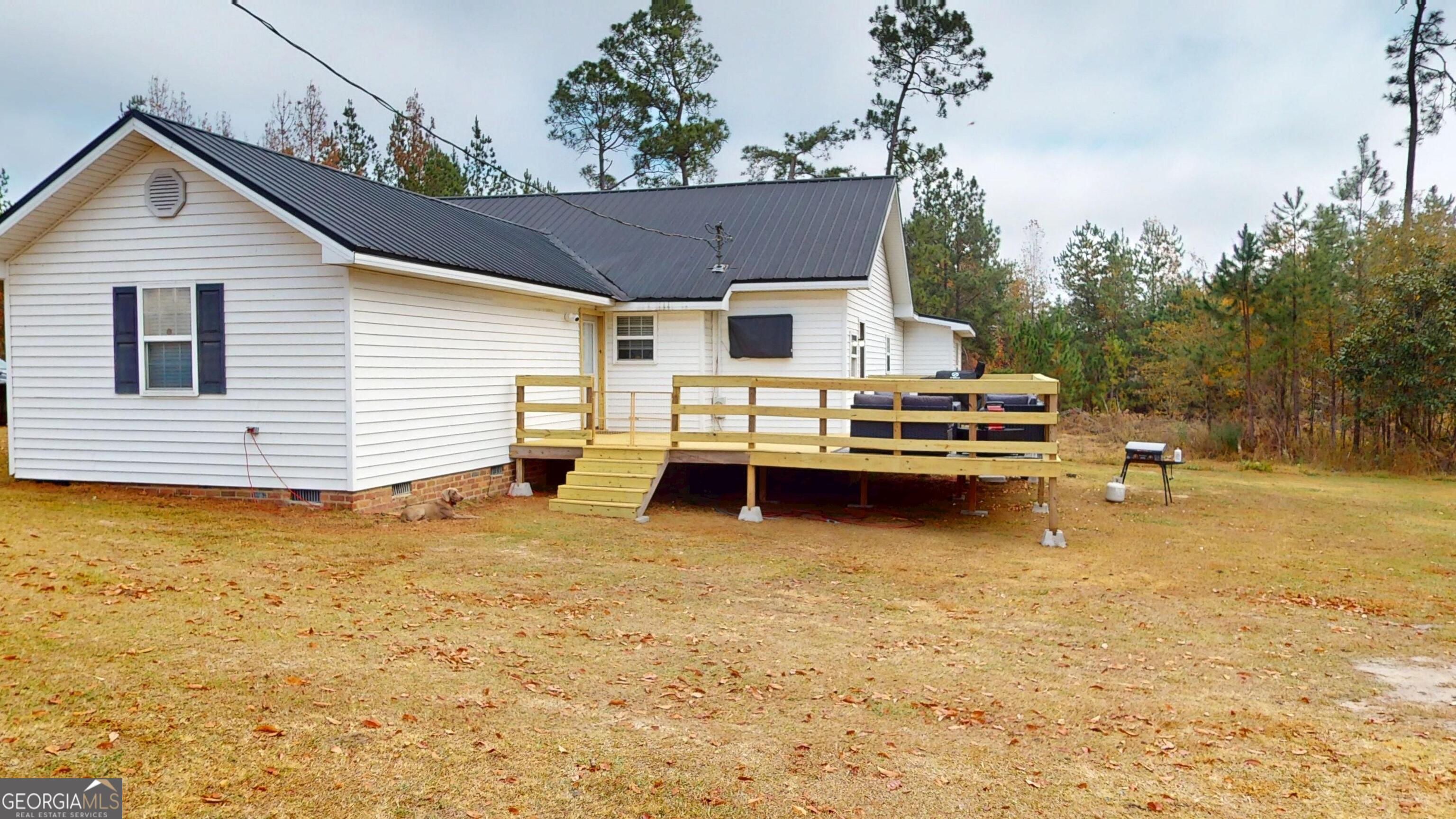 184 Eagle Pass Swainsboro, GA 30401 - Photo 49 of 49 a view of a house with pool and chairs