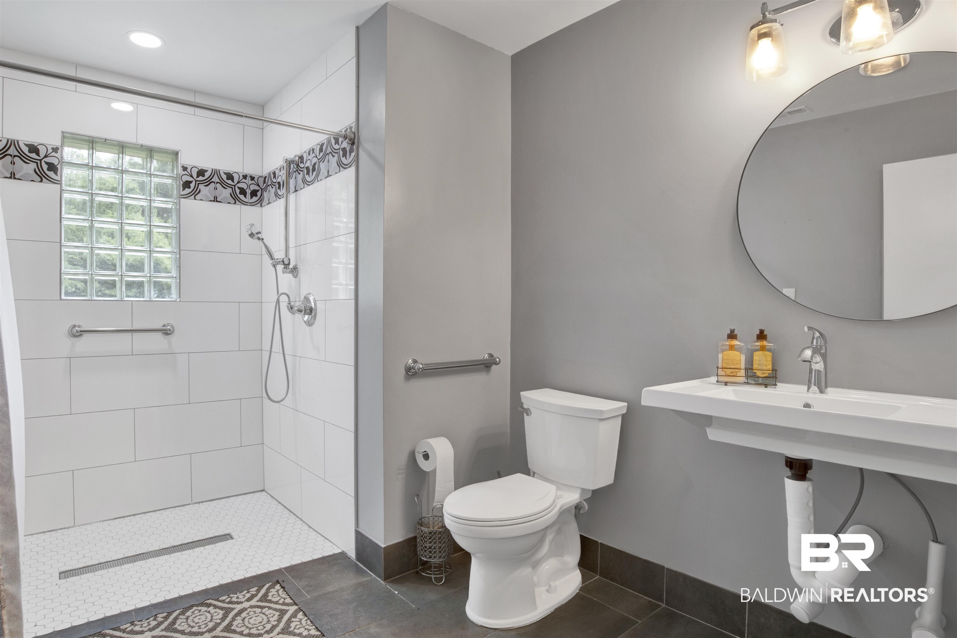 17714 Horseneck Road Bay Minette, AL 36507 - Photo 18 of 36 Bathroom featuring a curbless shower with white subway tile, decorative accent tile, and a glass block window