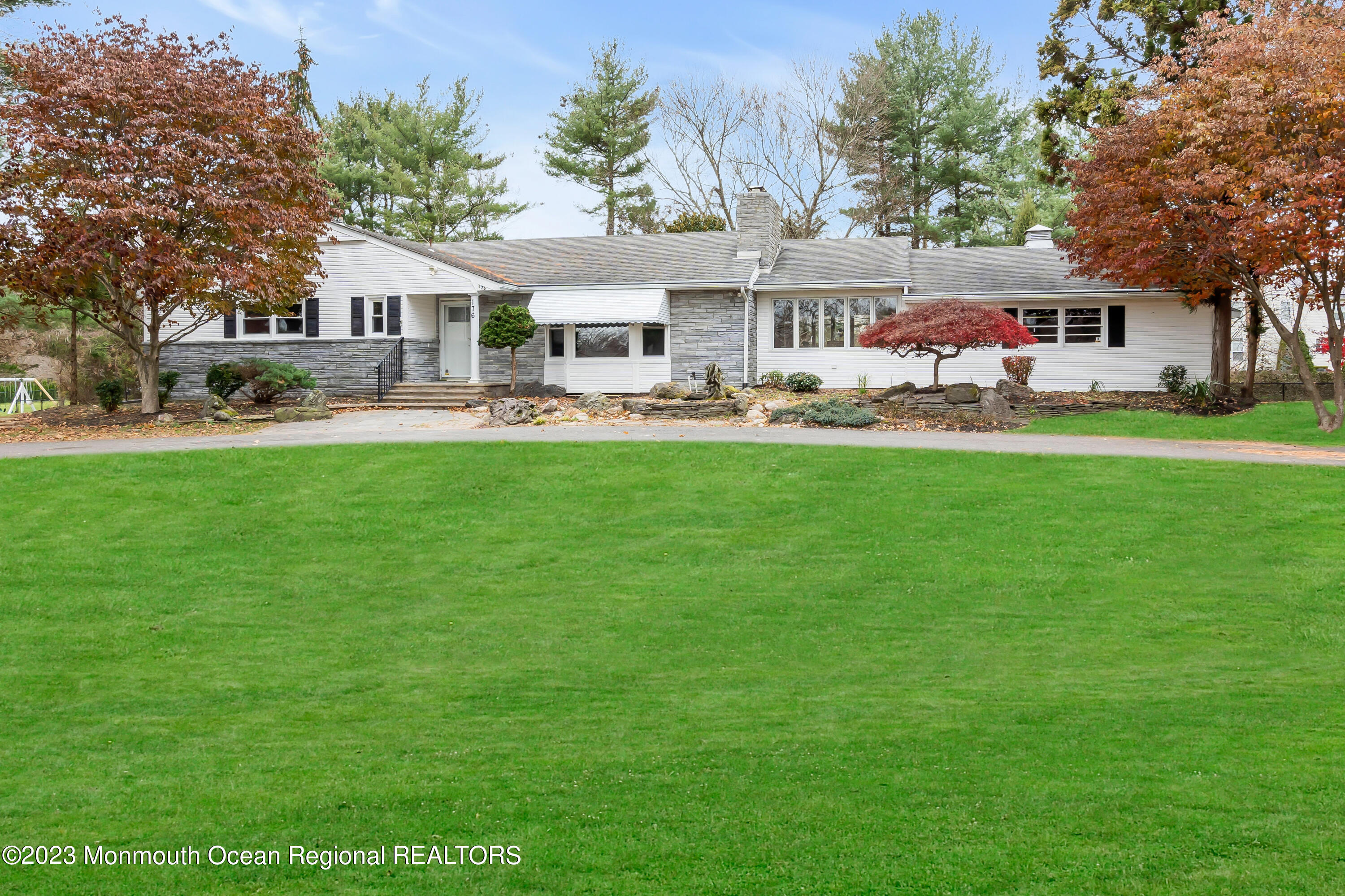 a front view of a house with yard patio and swimming pool