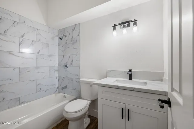 a bathroom with a sink a toilet and a bathtub