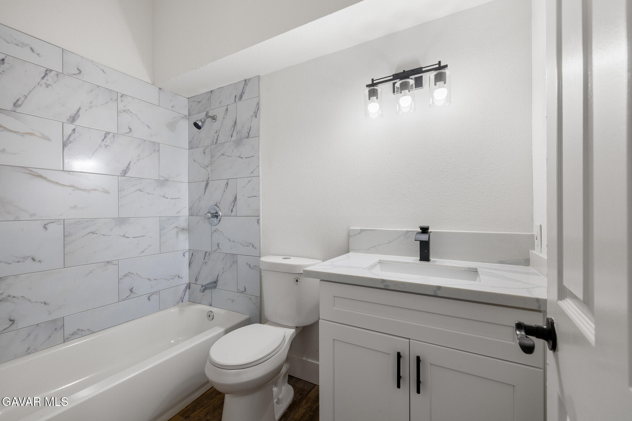 4753 East Ave R 11 Palmdale, CA 93552 - Photo 18 of 41 a bathroom with a sink a toilet and a bathtub