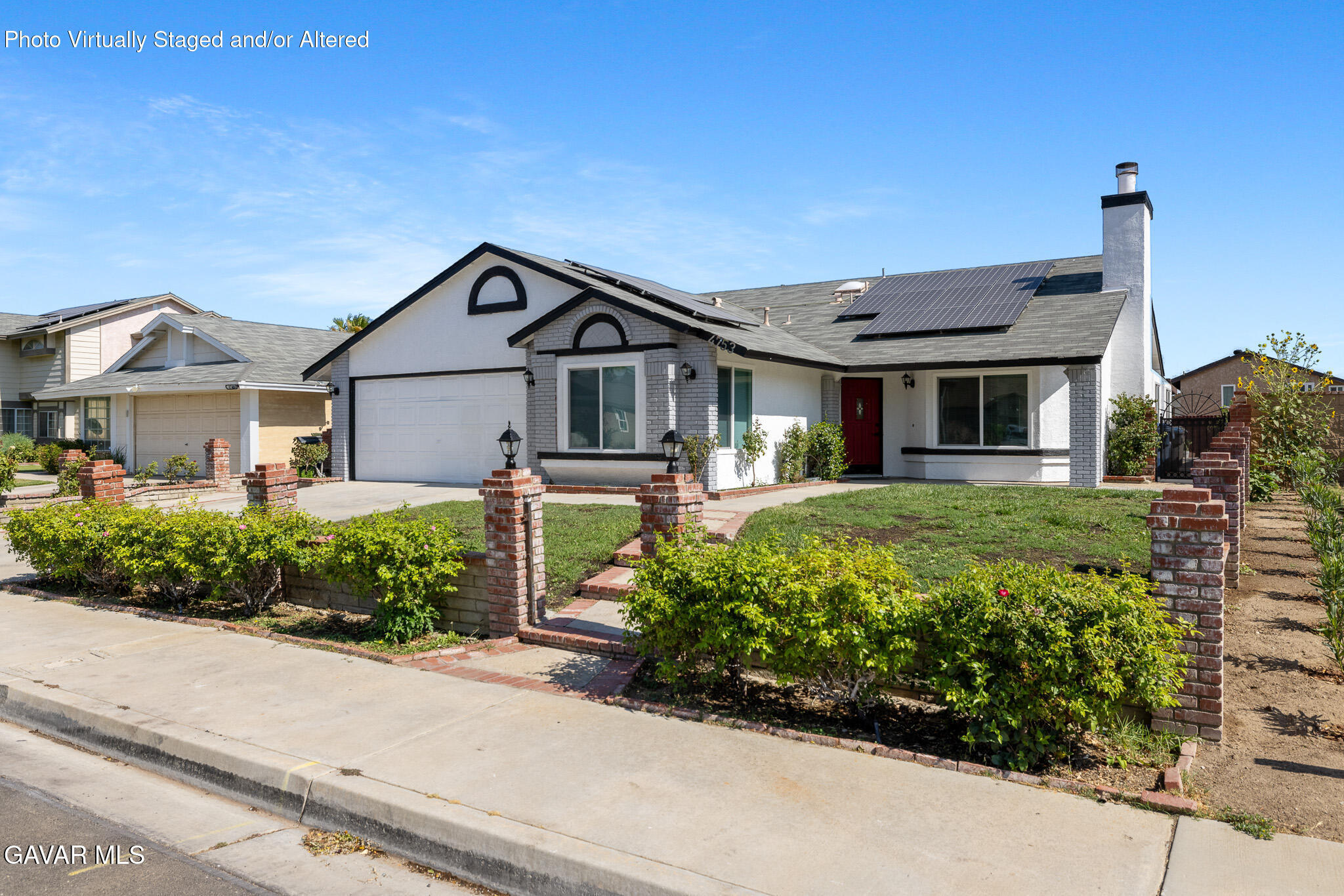 4753 East Ave R 11 Palmdale, CA 93552 - Photo 2 of 41 a front view of a house with a yard and potted plants