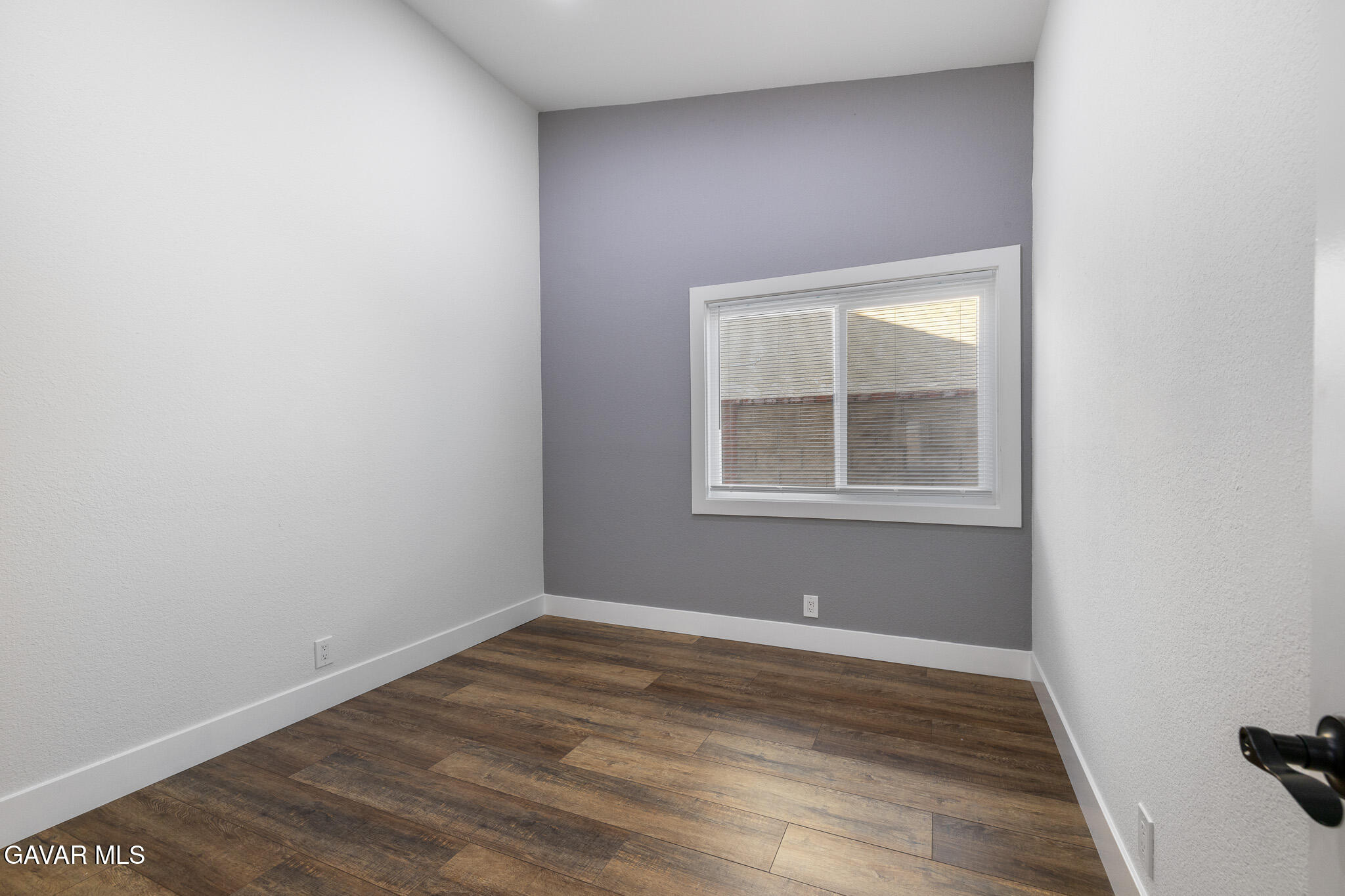 4753 East Ave R 11 Palmdale, CA 93552 - Photo 21 of 41 an empty room with wooden floor and windows