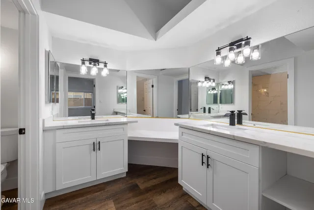 a spacious bathroom with a double vanity sink and a mirror