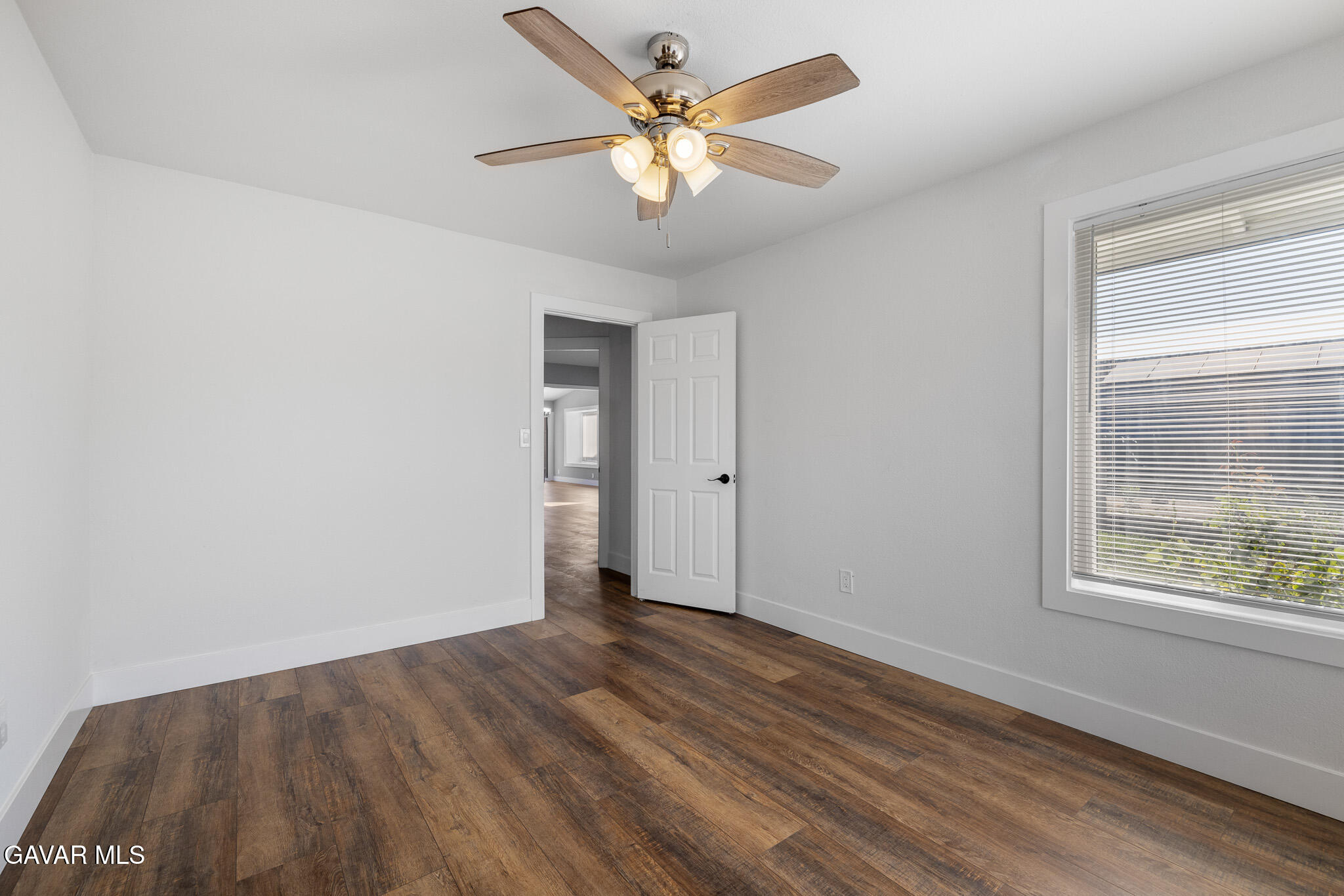 4753 East Ave R 11 Palmdale, CA 93552 - Photo 30 of 41 wooden floor in an empty room with a window