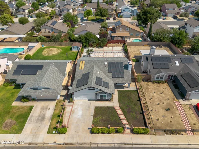 an aerial view of a residential houses with outdoor space