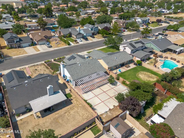 an aerial view of residential houses with outdoor space