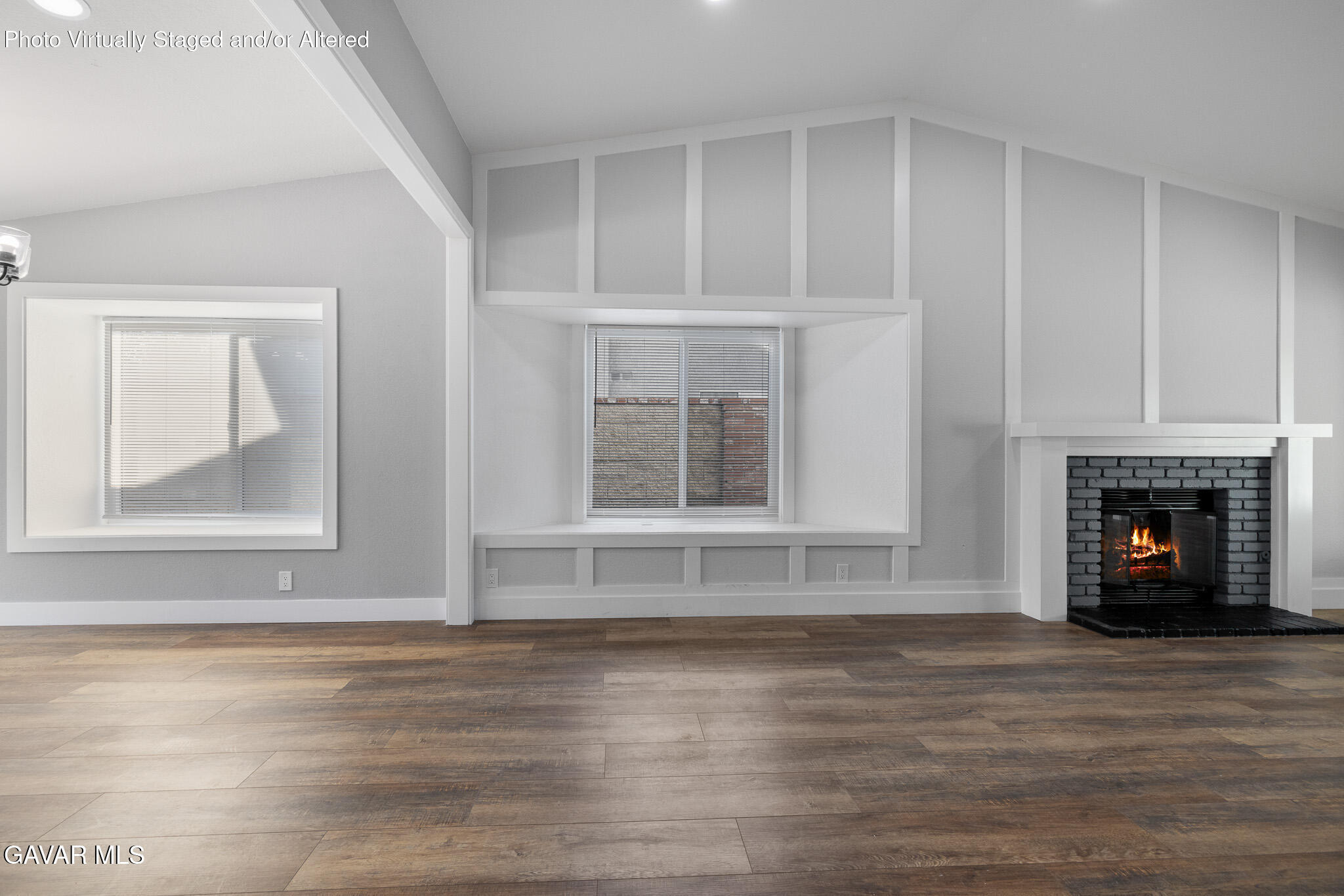 4753 East Ave R 11 Palmdale, CA 93552 - Photo 9 of 41 a view of an empty room with wooden floor fireplace and a window