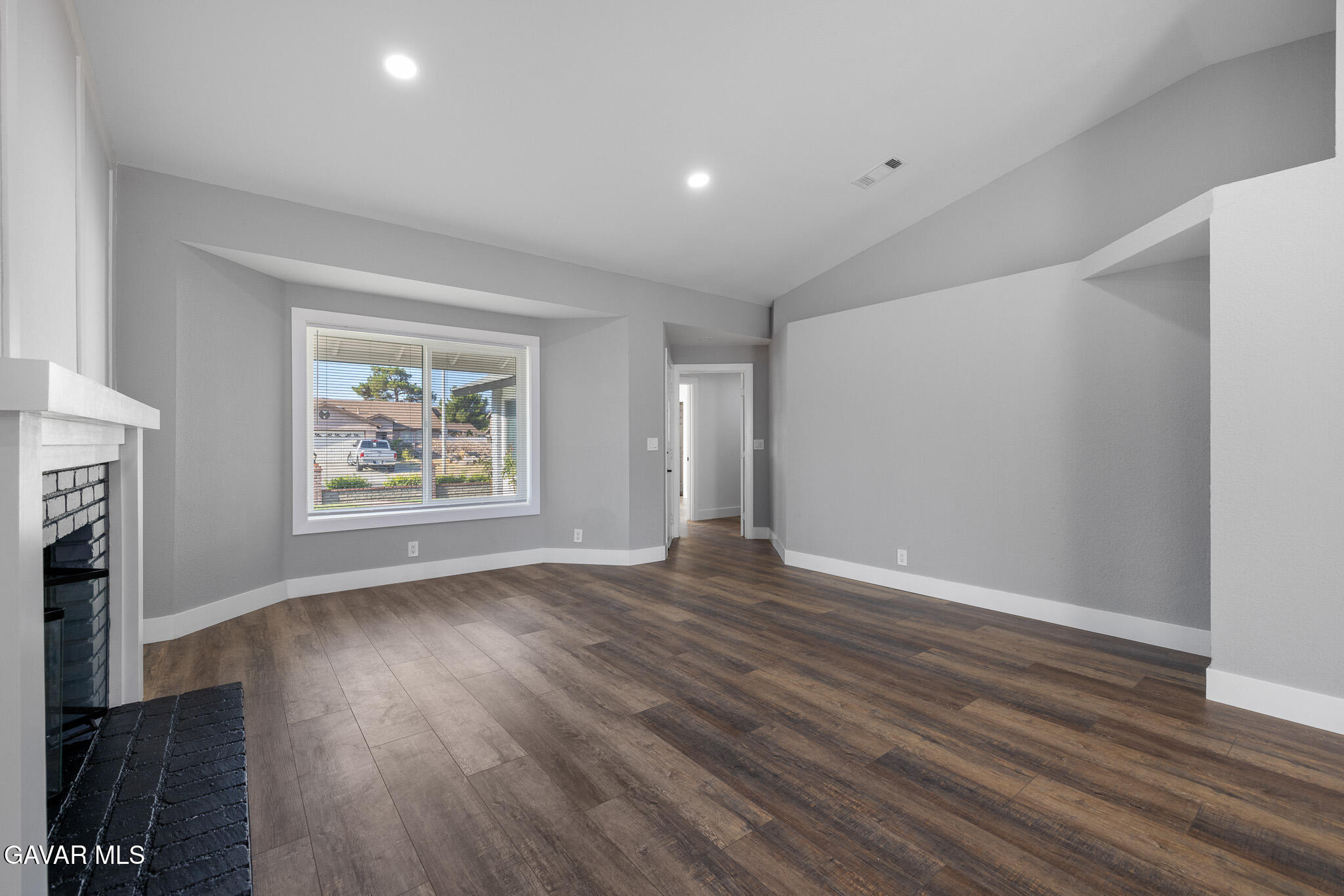 4753 East Ave R 11 Palmdale, CA 93552 - Photo 10 of 41 an empty room with wooden floor and a window