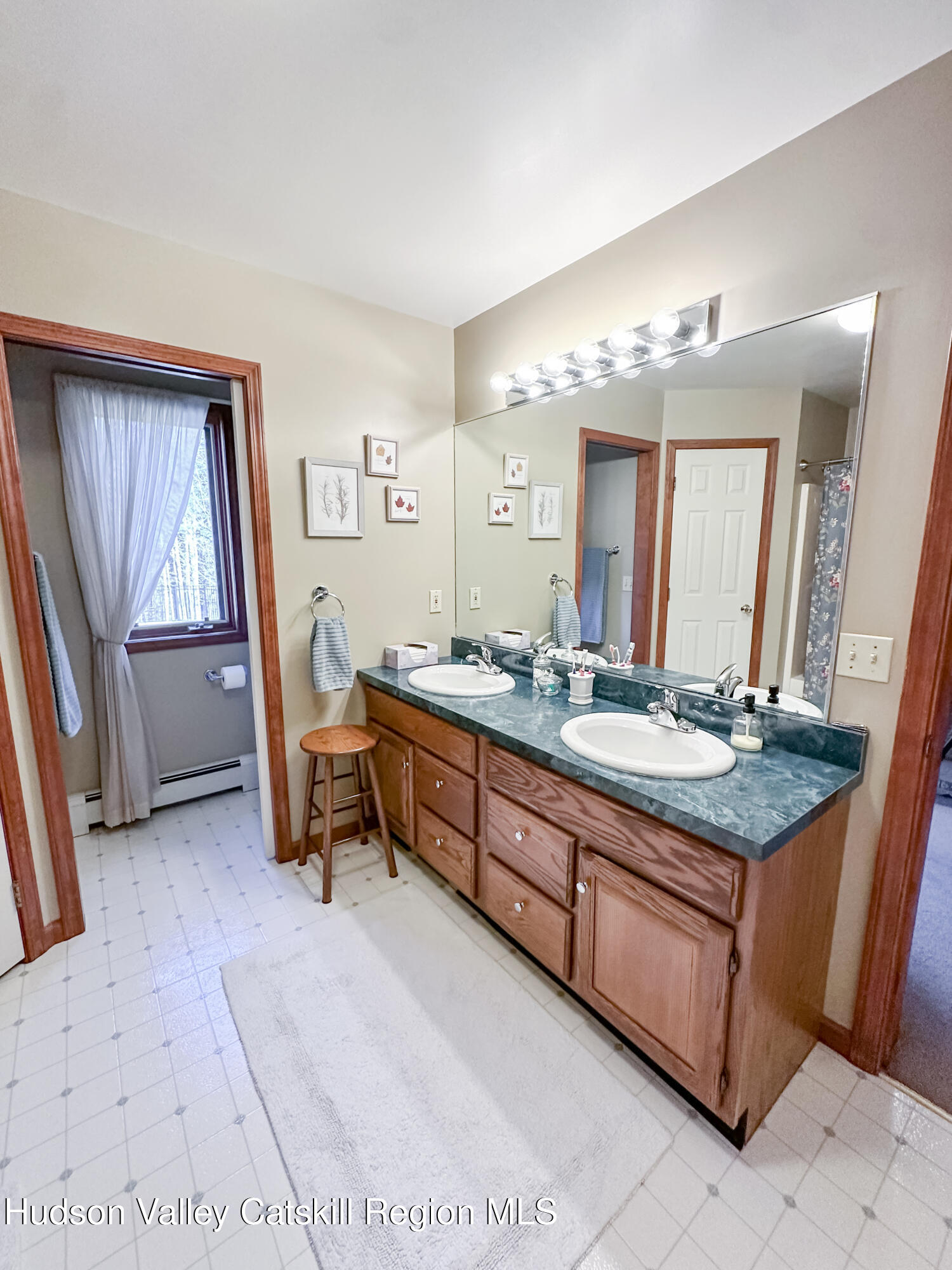 596 Joseph Chadderdon Road Acra, NY 12405 - Photo 17 of 55 a spacious bathroom with a granite countertop sink and a mirror