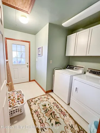 a spacious bathroom with a granite countertop sink a toilet a mirror and shower