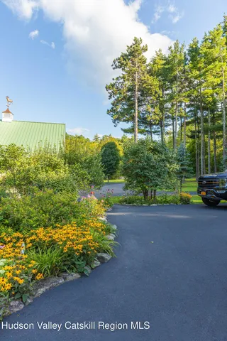 an aerial view of a house with swimming pool and garden