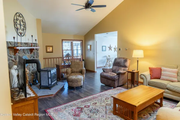 a living room with furniture a rug and a fireplace