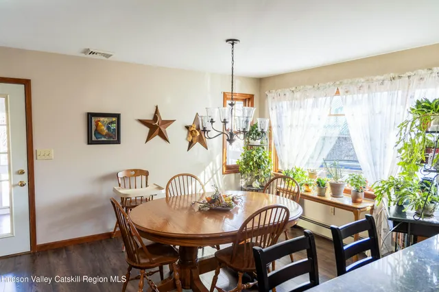 a dining room with furniture a window and wooden floor
