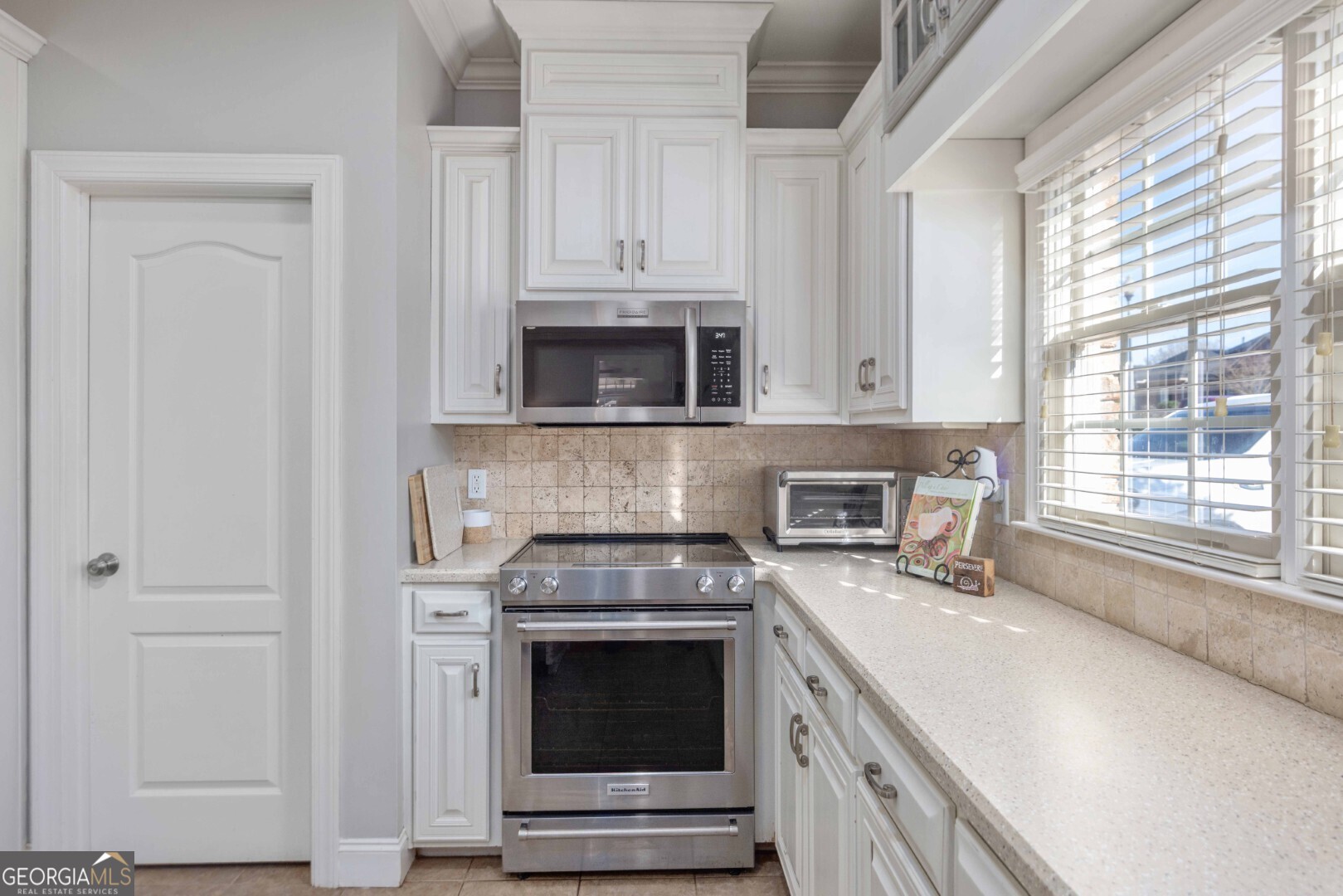 6742 Bridge Way Columbus, GA 31904 - Photo 20 of 45 a kitchen with stainless steel appliances granite countertop white cabinets and a stove top oven
