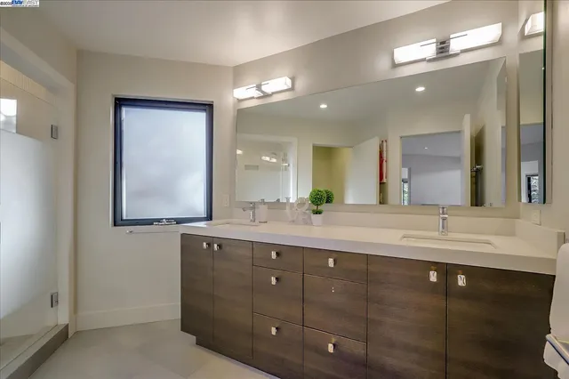 a bathroom with a double vanity sink and a mirror