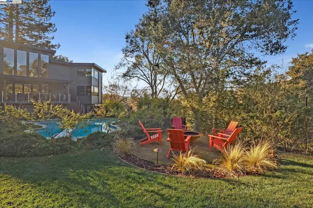 a backyard of a house with table and chairs