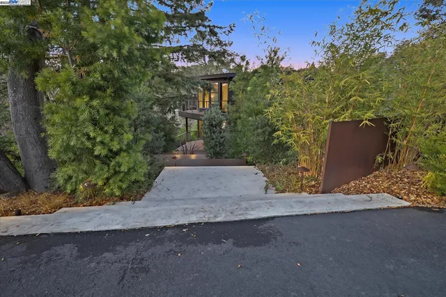 a view of a deck with couches table and chairs with wooden floor and fence