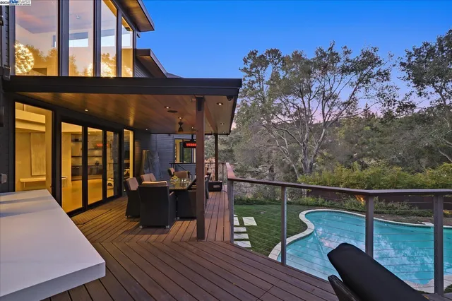 a backyard of a house with table and chairs
