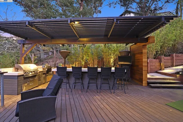 a roof deck with wooden floor and outdoor seating
